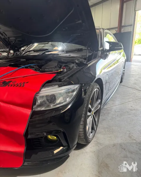 Air conditioning service hoses connected to a car's system with the bonnet up