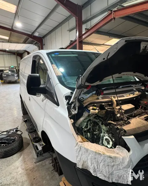 A Ford Transit Custom in the workshop with the front end stripped down for engine work