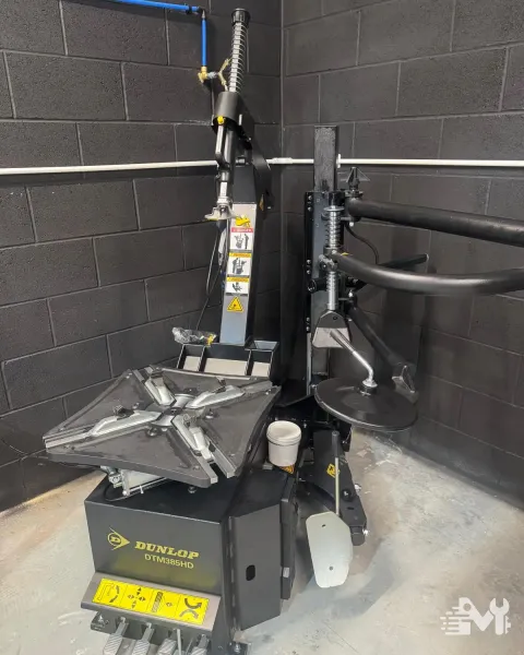 The workshop tyre changer, set up for fitting and removing tyres from alloy wheels